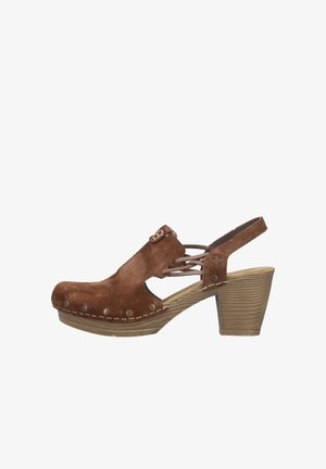 Brown suede women's clog sandal with cutouts, metal studs, crisscross straps, buckle detail, and stacked wooden block heel.