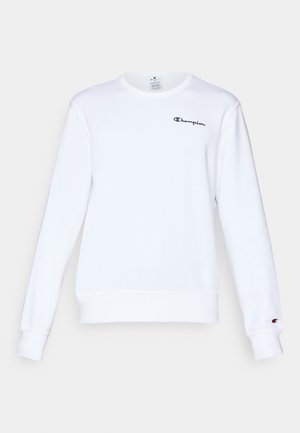 Sudadera de algodón blanca con mangas largas, cuello redondo, puños y dobladillo acanalados, que presenta un pequeño logo negro de "Champion" en el pecho.