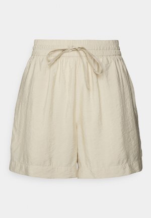 Shorts décontractés couleur crème avec une ceinture élastique et un cordon, fabriqués en tissu léger texturé.
