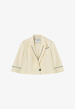 Kremfarvet cropped blazer med sort piping på revers, manchetter, enkelt foran knap og brystlomme, med en skræddersyet krave og lange ærmer.