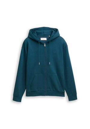 Turkizna zip-up huoodie, izdelana iz mehkega materiala, z kenguru žepom, nastavljivim kapuco in ribastimi manšeti. Ima logo na prsih.