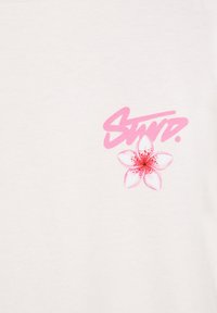 Pink stylized text reading "Stay" above a pink and white five-petal flower on a plain white background.