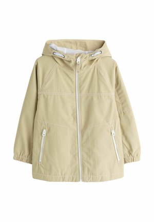 Bézs kapucnis dzseki elülső cipzárral, elasztikus mandzsettákkal, két cipzáras oldalzsebbel és fehér behúzózsinórokkal a kapucnin.