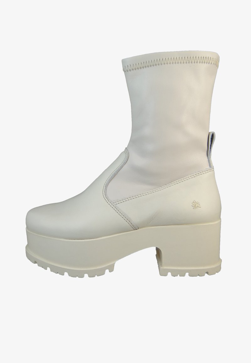White leather ankle boot with a rounded toe, raised platform sole, and a textured upper. Features a seam detail and a logo on the heel.