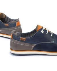 Navy and gray leather shoes with white laces, orange accents, and striped inner lining. Features durable stitching and textured surfaces.