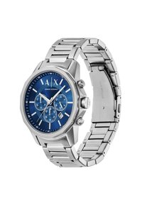 L'orologio in metallo argentato presenta un quadrante blu con indici bianchi, tre sottodial e una cassa di forma ottagonale. Bracciale in acciaio inossidabile con maglie.