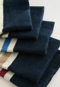 Knitted fabric swatches in varying shades of navy, with cream, brown, and red stripes. Textured, soft finish with a cozy appearance.