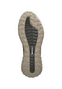 Semelle en caoutchouc avec des crampons profonds et multidirectionnels pour une adhérence, présentant une section centrale noire et un contour beige. Logo de la marque visible.