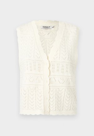 Cardigan blanc sans manches en tricot avec boutons sur le devant et bords festonnés, présentant des motifs complexes en dentelle.