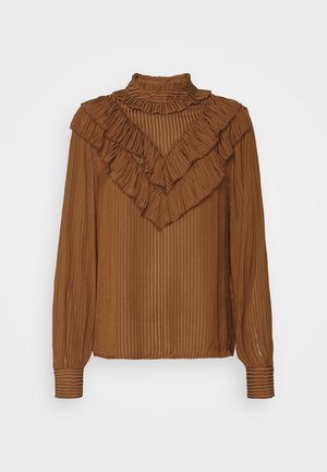 Brun bluse med lange ærmer med lodrette striber, en høj flæset krave og lagdelte flæser, der danner en V-form på brystet.