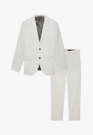 Biały garnitur w paski, składający się z jednorzędowej marynarki z klapami i dopasowanych spodni, wykonany z gładkiego materiału o eleganckim wykończeniu.