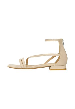 Beige flat sandal made of smooth leather. Features two front straps, ankle strap with zip closure, and a low block heel.