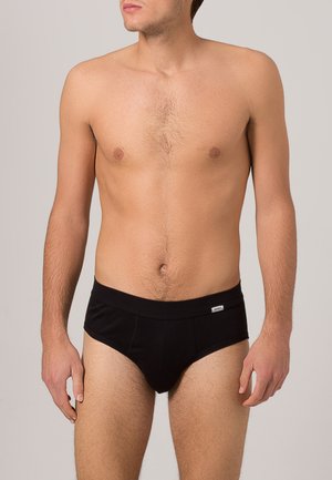 Zwarte slip met een zachte elastische tailleband, voorzien van een minimalistisch ontwerp en een klein merkembleem aan de voorkant.
