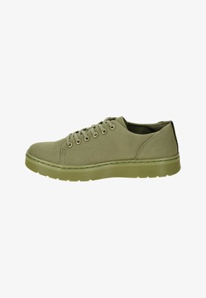 Green canvas sneaker with round toe, six eyelets, textured rubber sole, and contrasting black heel accent. Simple, lightweight design.
