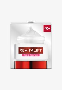 Vit krämburk med klar bas, röda detaljer och ett vitt lock. Etiketten säger "Revitalift" och "Ohne Parfum," med en röd ruta som indikerar 40+.