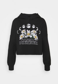 Sudadera corta negra con un gráfico de margarita y fases de la luna sobre el texto "SOÑADOR CÓSMICO" en la parte frontal, que cuenta con mangas largas y capucha con cordón.