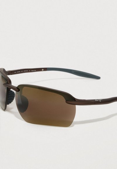 Brown framed rimless sunglasses with gradient lenses and blue rubberized temple tips resting on a white surface.