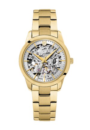 Montre-bracelet en métal doré avec engrenages mécaniques détaillés visibles, index dorés et trois aiguilles dorées indiquant 10:10:38.