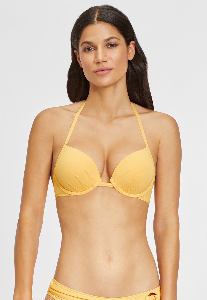 Gelber BikinOberteil mit geformten Cups, verstellbaren dünnen Trägern und subtiler texturierter Außenfläche. Entwickelt für eine figurbetonte Silhouette.