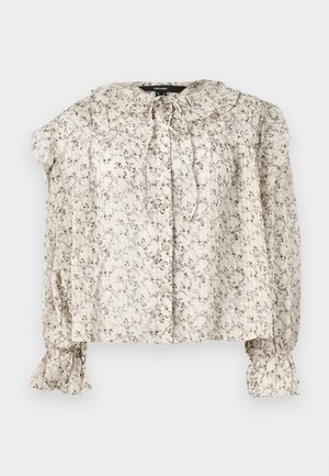 Leichte, cremefarbene Bluse mit kleinem floralen Muster. Mit Rüschensaum, Bindegürtel und gerafften Ärmeln mit weit ausgestellten Manschetten. Fünf Knöpfe.