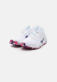 White athletic shoes with a textured upper, purple accents, and a multicolored patterned sole in red, blue, and white. Laced design with padded collar.