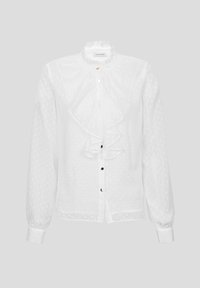White blouse with a ruffled collar and long sleeves, featuring a textured polka dot pattern and a button-down front with gold accents.