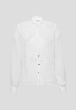 Bijela bluzica s ruflaste ovratnikom i dugim rukavima, koja ima teksturirani uzorak točkica i prednje kopčanje s dugmadi s zlatnim detaljima.