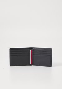 Black leather wallet with multiple card slots and a red, white, and blue stripe detail. Smooth texture, compact design. Interior is simple.