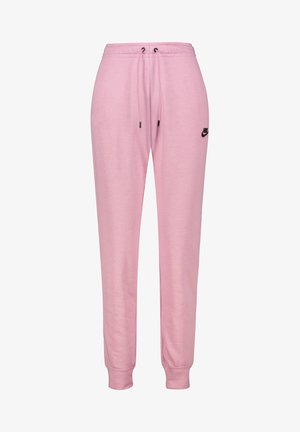 Pantalones de chándal Nike en rosa suave, con cintura ajustable con cordón, puños elásticos y un acento de logotipo negro en la parte superior de la pierna izquierda.