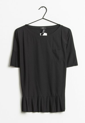 Blouse noire à manches courtes avec encolure dégagée et ourlet plissé, suspendue à un cintre noir sur fond blanc.