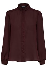 Blouse bourgogne en tissu léger, dotée d'un col haut, d'une patte de boutonnage froncée et de manches longues avec des poignets élastiques.