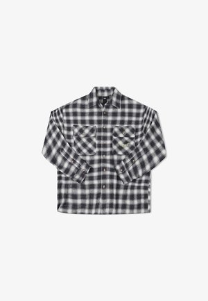 Black and white checkered flannel shirt with long sleeves, two chest pockets, and buttons, featuring a subtle green logo detail.