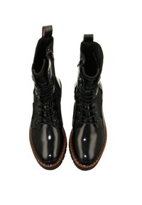 Black leather ankle boots with lace-up front, glossy finish, contrasting brown rubber sole, and decorative side zippers.