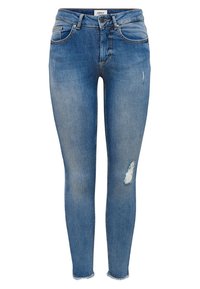 Jeans ajustados en denim azul desgastado con parches rasgados. Tienen una cintura de talle medio, cinco bolsillos y un dobladillo deshilachado en el tobillo.