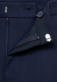 Námořnické kalhoty s uzávěrem na zip a knoflík, s boční kapsou. Tkanina je hladká, s precizním šitím a minimálními detaily kovových prvků.