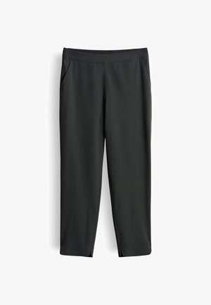 Pantalon noir longueur cheville avec ceinture élastique, poches latérales et petites fentes à l'avant sur fond blanc.