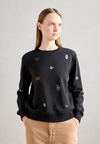 Felpa nera con vari ricami, tra cui foglie e motivi arancioni e rosa. Collo a giro e polsini a costine.