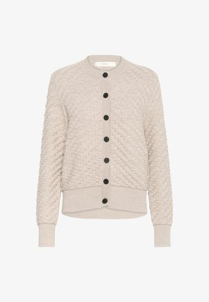 Bezs színű kötött kardigán texturált mintával, bordás mandzsettával és szegéllyel. Kerek nyakkivágással és hat fekete gombbal a frontján.