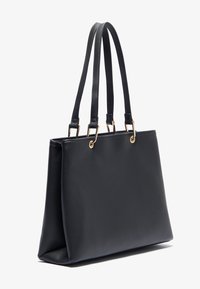 Black leather tote bag with two long handles, gold hardware accents, rectangular shape, smooth texture, and a structured bottom.