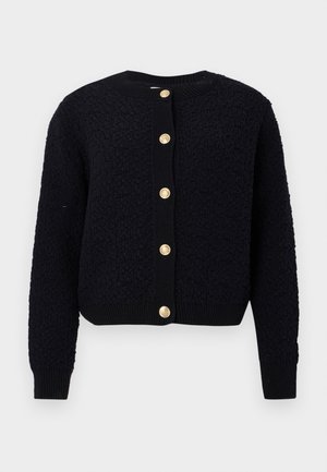 Mørkeblå strikket cardigan med et strukturert mønster, rund hals, og fem gullfargede knapper foran. Ribbestrikkede mansjetter og nederkant.