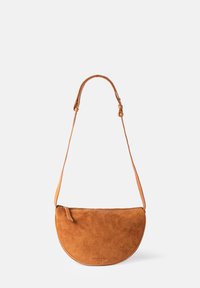 Brown suede half-moon shoulder bag with a smooth, textured finish and a long, adjustable leather strap. Features a top zipper closure.