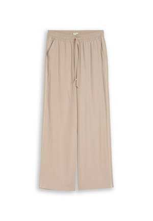 Beige weite Hose mit elastischem Bund, Kordelzug, seitlichen Taschen und dezenten weißen Paspeln entlang der äußeren Nähte.