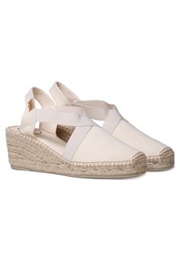 White canvas wedge sandals with cross-strap design and jute-wrapped heel; round toe with stitched accent at the front.