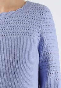 Maglione a maglia lavanda chiaro con un motivo testurizzato sulle spalle e sulle maniche superiori, caratterizzato da un collo e un orlo a coste.