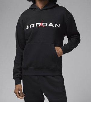 Hoodie noir en tissu doux, avec une poche avant et le texte blanc "JORDAN" accompagné d'un logo rouge, sur fond neutre.