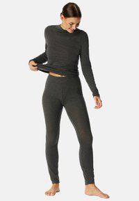 Grijs langwerpig shirt met lange mouwen en aansluitende legging van een zachte, rekbare stof. Het shirt heeft een hoge hals en de legging heeft een naadloze tailleband.
