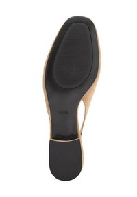 Beige suede high-heeled shoe with a black rubber sole. The sole features a textured grip and rounded shape, enhancing stability.