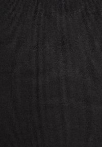 Svart stickad tyg med en slät yta och en jämn, tät väv. Inga synliga mönster eller utsmyckningar.