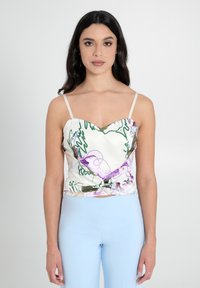 Top in satin bianco con scollatura a cuore, modelli astratti colorati in verde e viola, con dettaglio nodoso davanti.