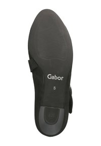 Black suede shoe sole with textured surface; features brand name "Gabor" and size "5" printed on the heel. Rounded toe design.